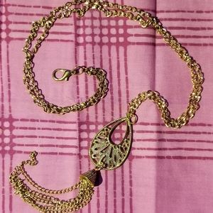 Long golden pendant necklace.